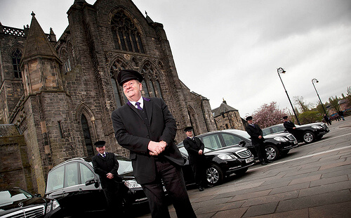 hearse drivers outside a church